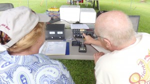 Bill KR4LO provides radio function instruction to event attendee, Joy McCracken.