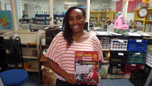 Ms. DaHonna Moore accepts the new Technician level manual for the Pamlico County Library